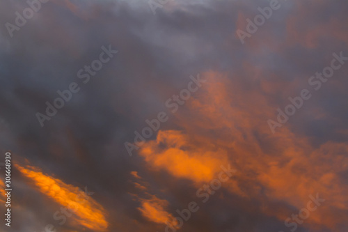 Orange and dark grey clouds close up