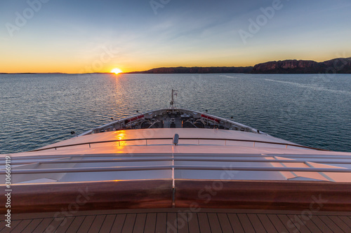 Sunset view of Prince Frederick Harbor in the remote Kimberley coast of Western Australia from the deck of an anchored expedition cruise ship. © Philip Schubert