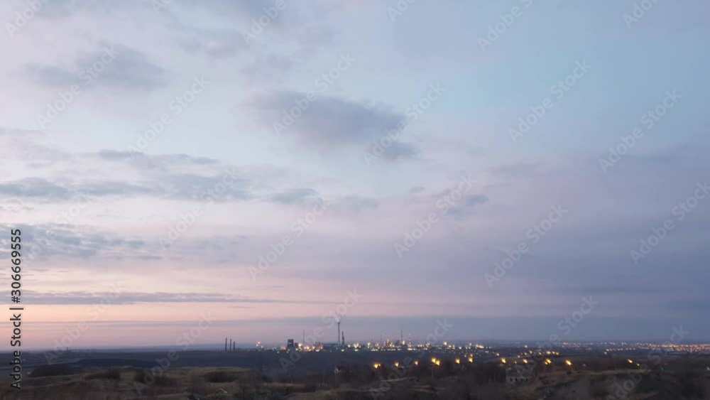 industrial enterprise with pipes and city in evening lights at sunset, 4K timelapse industrial enterprise with pipes and city in evening lights at sunset, 4K timelapse