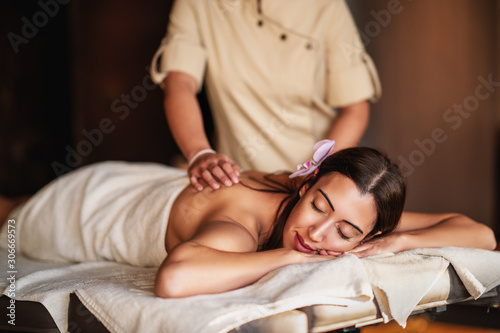 woman having a relaxation massage in a spa center.