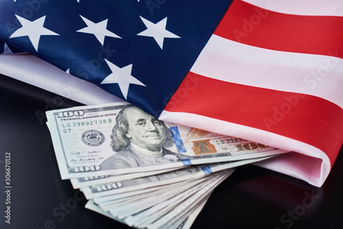 USA national flag and dollar bills on a dark background. Business and finance concept