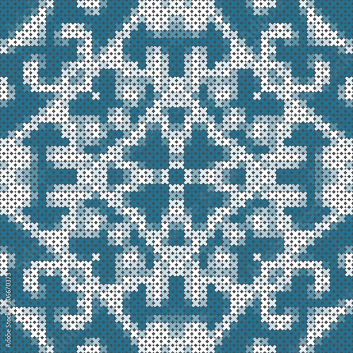 Cross stitch pattern with symmetric ornament in blue and white colors. Seamless pattern.
