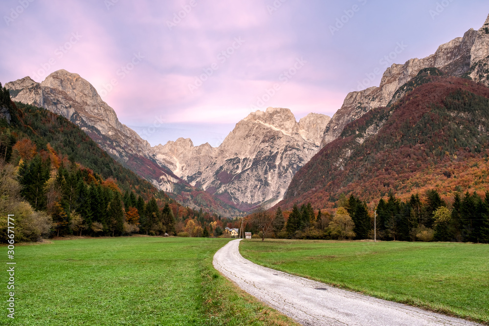 Koritnica valley located near Log Pod Mangartom in the northern part of Slovenia in the Soca Region. Triglav National Park and Julian Alps in the background during fall season.