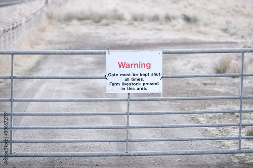 Farm livestock in area warning sign keep gate shut at farm