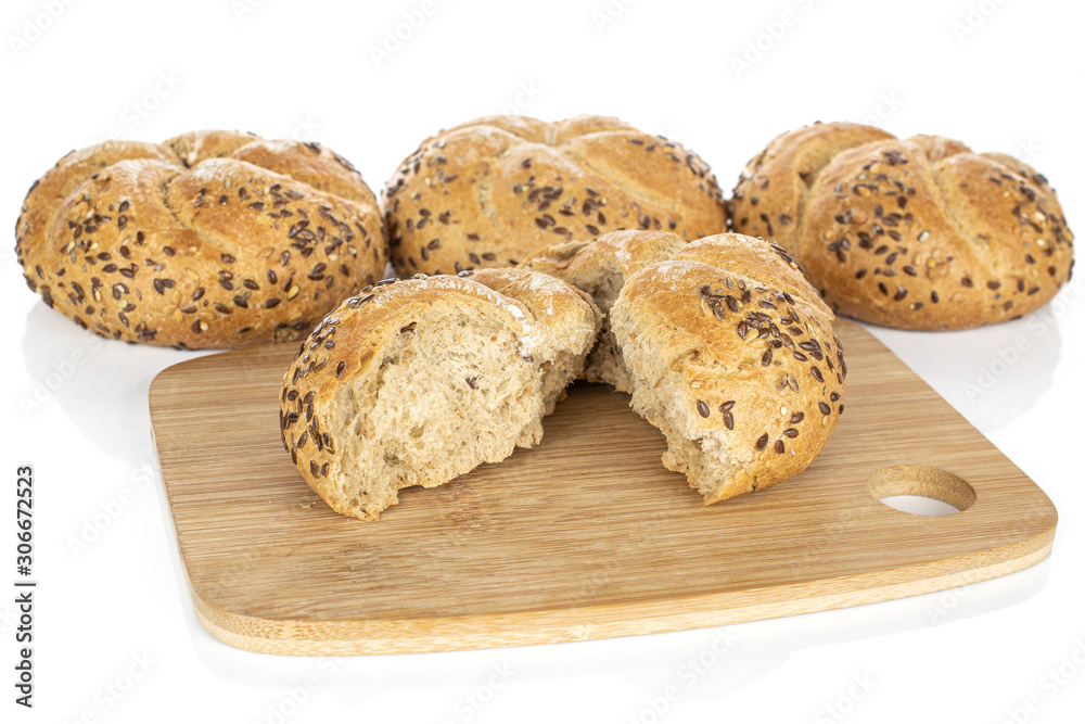 Group of three whole two halves of sesame kaiser roll on bamboo cutting board isolated on white background Group of three whole two halves of sesame kaiser roll on bamboo cutting board isolated on white background