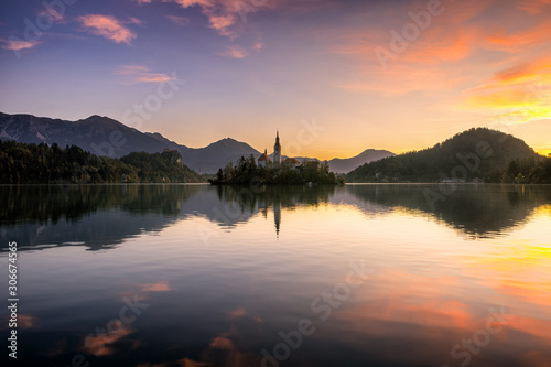 Beautiful reflection of Lake Bled and it's surround during sunrise in fall season.