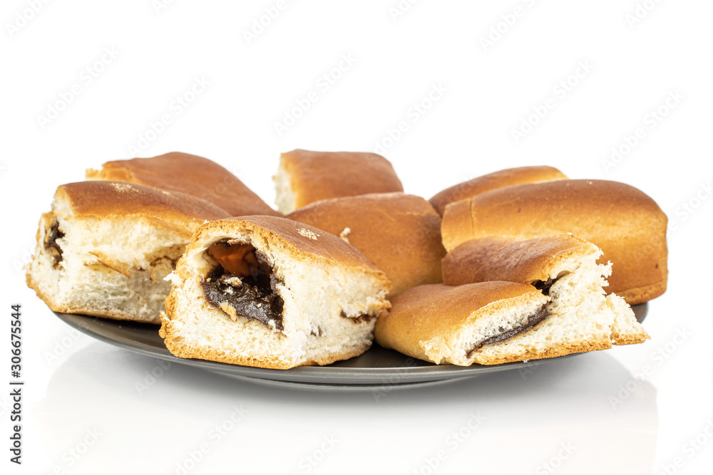 Lot of whole sweet czech bun on gray ceramic plate isolated on white background