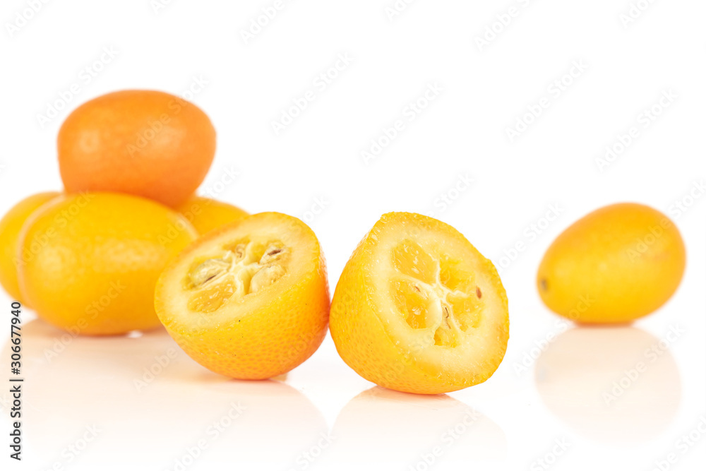Group of five whole two halves of tasty orange kumquat isolated on white background Group of five whole two halves of tasty orange kumquat isolated on white background
