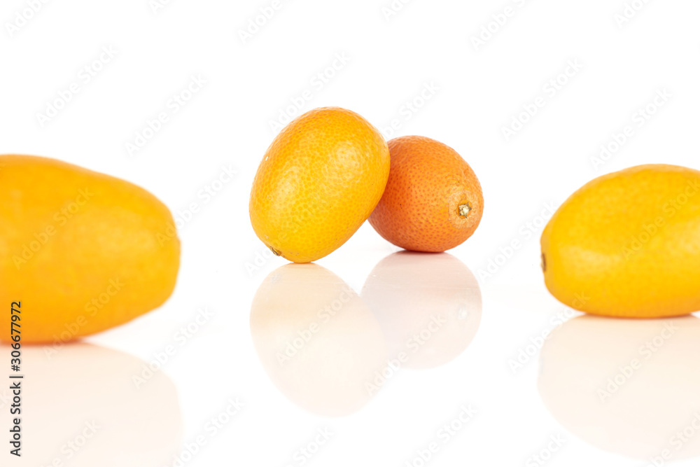 Group of four whole tasty orange kumquat isolated on white background Group of four whole tasty orange kumquat isolated on white background