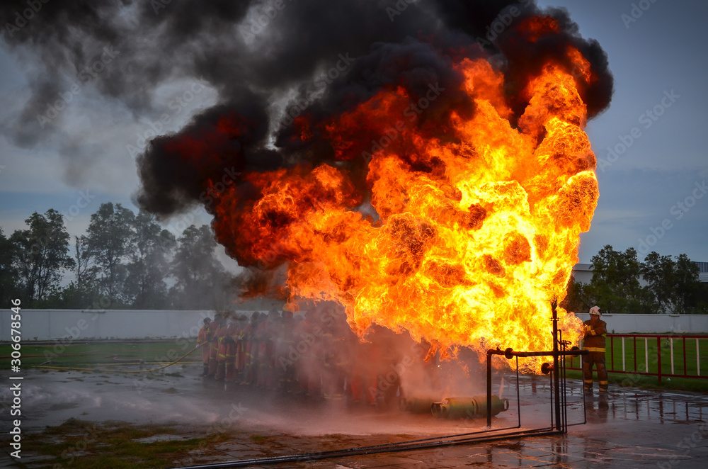People are practicing fire extinguishers with water. People are practicing fire extinguishers with water.