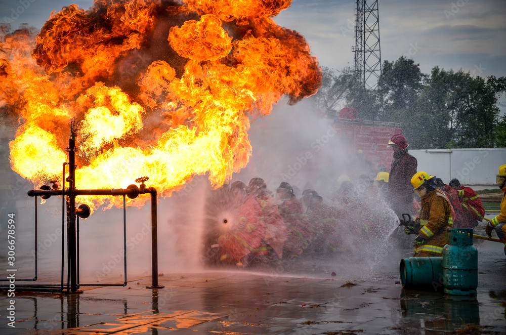 People are practicing fire extinguishers with water.