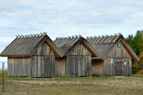 Three wooden sheds by the sea