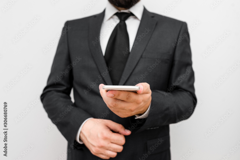 Male human wear formal work suit hold smart hi tech smartphone use one hand Male human wear formal work suit hold smart hi tech smartphone use one hand