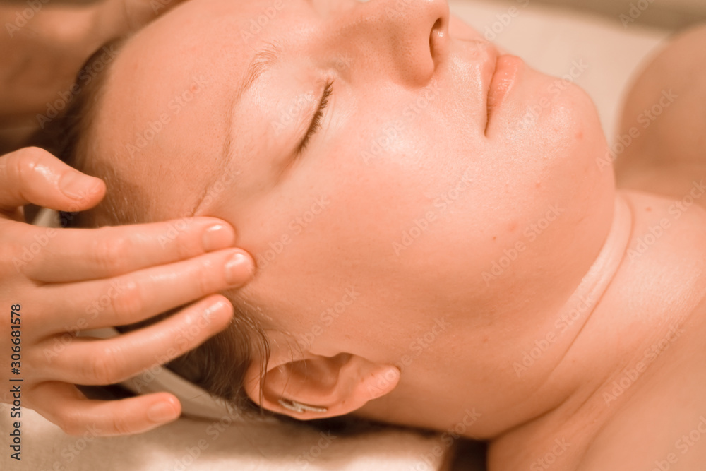 Beautiful plus size middle age woman getting a face massage treatment at beauty salon. close up step by step Beautiful plus size middle age woman getting a face massage treatment at beauty salon. close up step by step