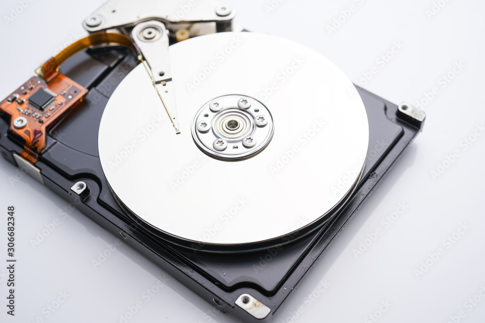 Disassembled hard drive from the computer, hdd with mirror effect. Opened hard drive from the computer hdd with mirror effects. Part of computer pc, laptop Disassembled hard drive from the computer, hdd with mirror effect. Opened hard drive from the computer hdd with mirror effects. Part of computer pc, laptop