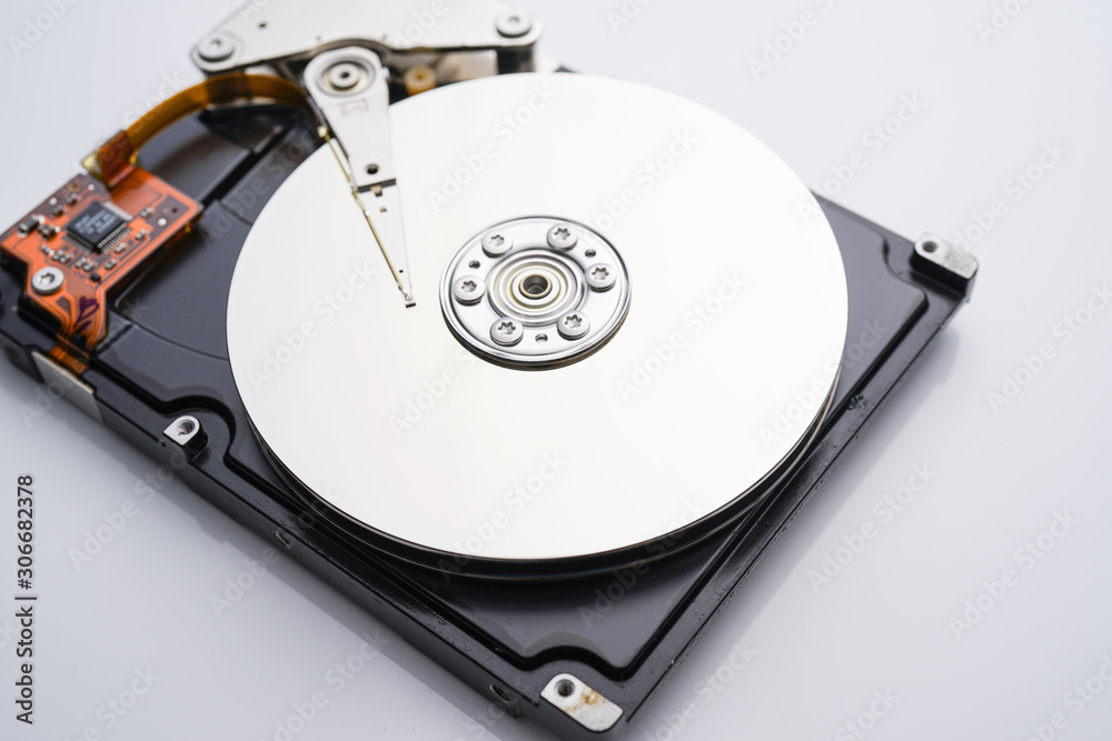 Disassembled hard drive from the computer, hdd with mirror effect. Opened hard drive from the computer hdd with mirror effects. Part of computer pc, laptop Disassembled hard drive from the computer, hdd with mirror effect. Opened hard drive from the computer hdd with mirror effects. Part of computer pc, laptop