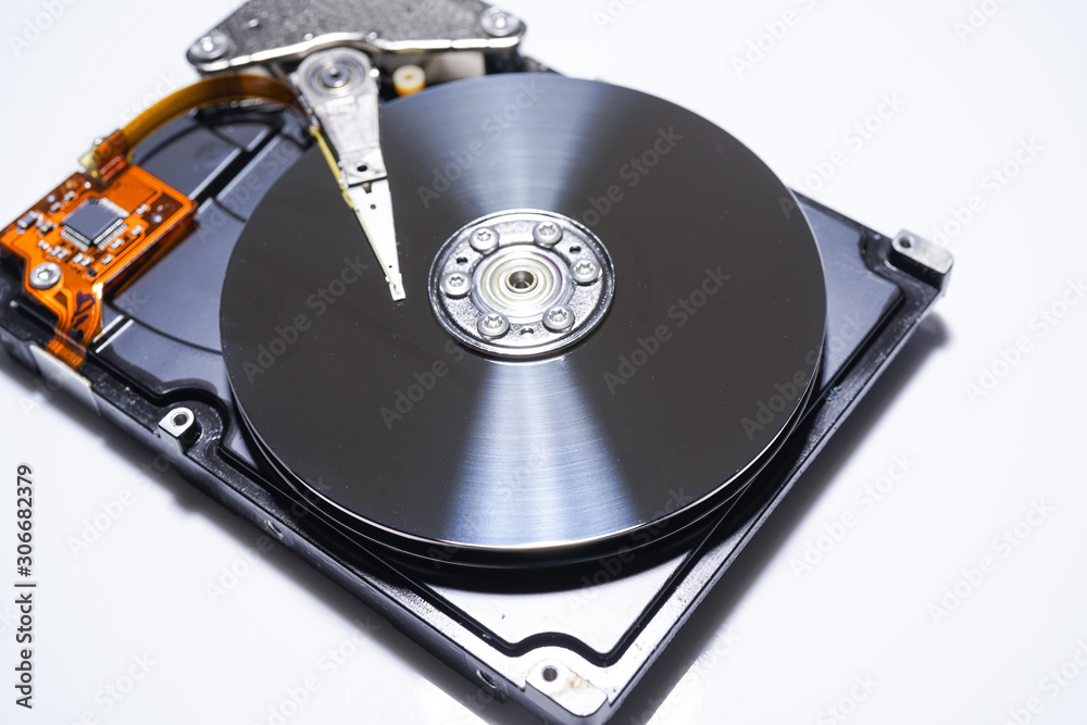 Disassembled hard drive from the computer, hdd with mirror effect. Opened hard drive from the computer hdd with mirror effects. Part of computer pc, laptop Disassembled hard drive from the computer, hdd with mirror effect. Opened hard drive from the computer hdd with mirror effects. Part of computer pc, laptop