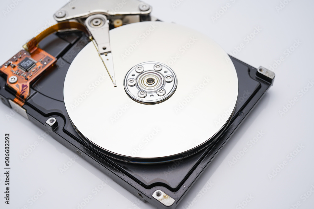 Disassembled hard drive from the computer, hdd with mirror effect. Opened hard drive from the computer hdd with mirror effects. Part of computer pc, laptop Disassembled hard drive from the computer, hdd with mirror effect. Opened hard drive from the computer hdd with mirror effects. Part of computer pc, laptop