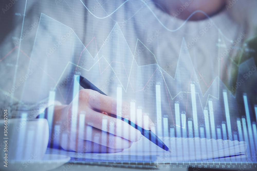 Forex chart displayed on woman's hand taking notes background. Concept of research. Multi exposure Forex chart displayed on woman's hand taking notes background. Concept of research. Multi exposure