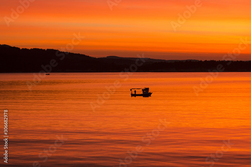 Orange sunset and the boat © umitarda