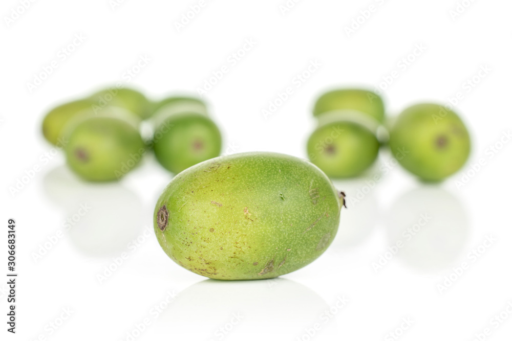 Lot of whole hardy green kiwi front focus isolated on white background Lot of whole hardy green kiwi front focus isolated on white background