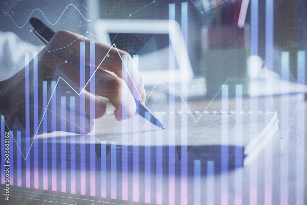 Financial charts displayed on woman's hand taking notes background. Concept of research. Double exposure Financial charts displayed on woman's hand taking notes background. Concept of research. Double exposure
