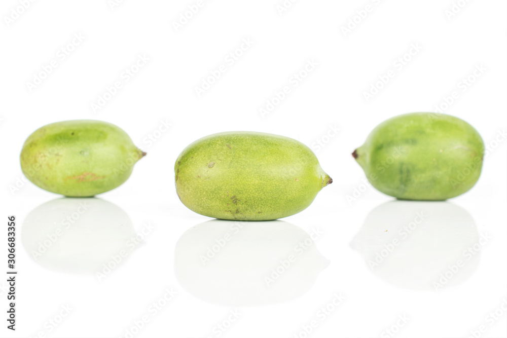 Group of three whole hardy green kiwi isolated on white background Group of three whole hardy green kiwi isolated on white background