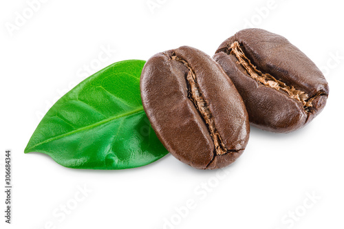 roasted coffee beans with leaves isolated on white background.
