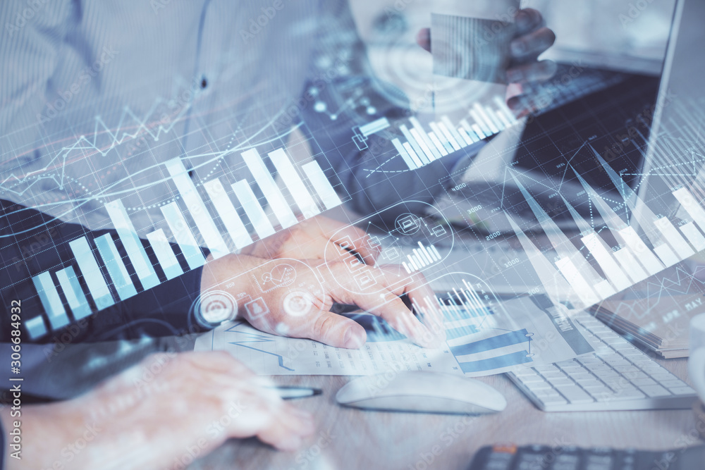 Multi exposure of chart with man typing on computer in office on background. Concept of hard work. Multi exposure of chart with man typing on computer in office on background. Concept of hard work.