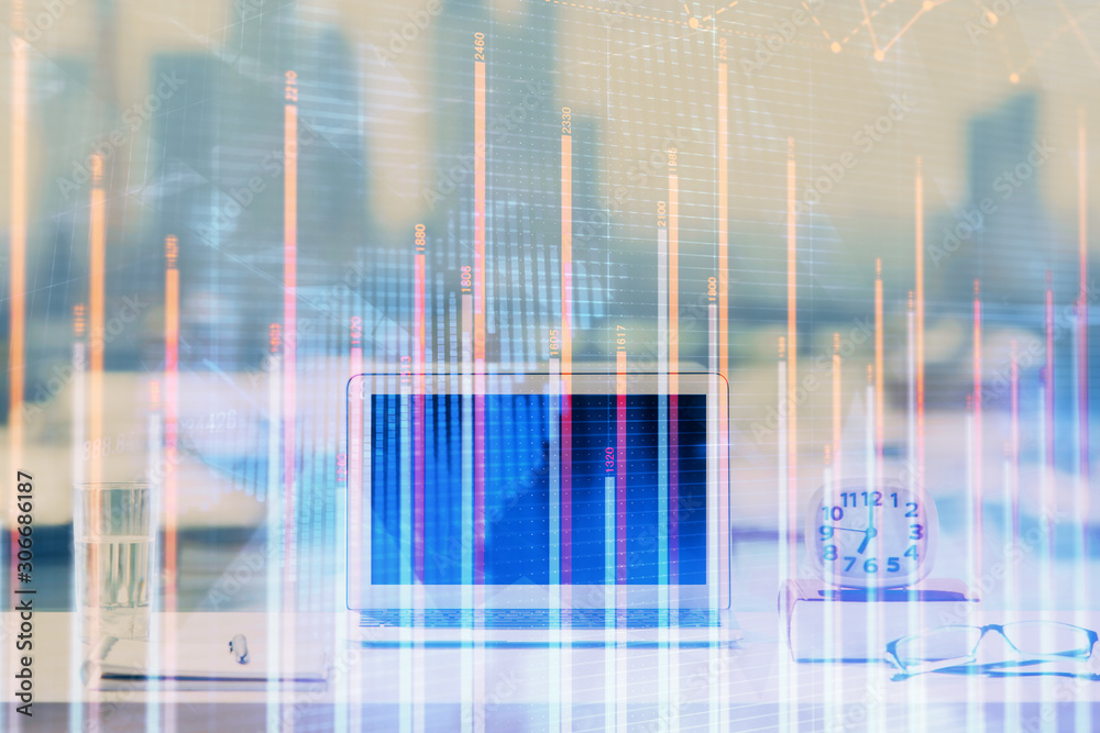 Forex Chart hologram on table with computer background. Double exposure. Concept of financial markets. Forex Chart hologram on table with computer background. Double exposure. Concept of financial markets.