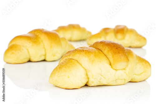 Group of four whole sweet golden mini croissant isolated on white background
