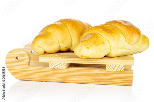 Group of two whole sweet golden mini croissant with wooden sledge isolated on white background