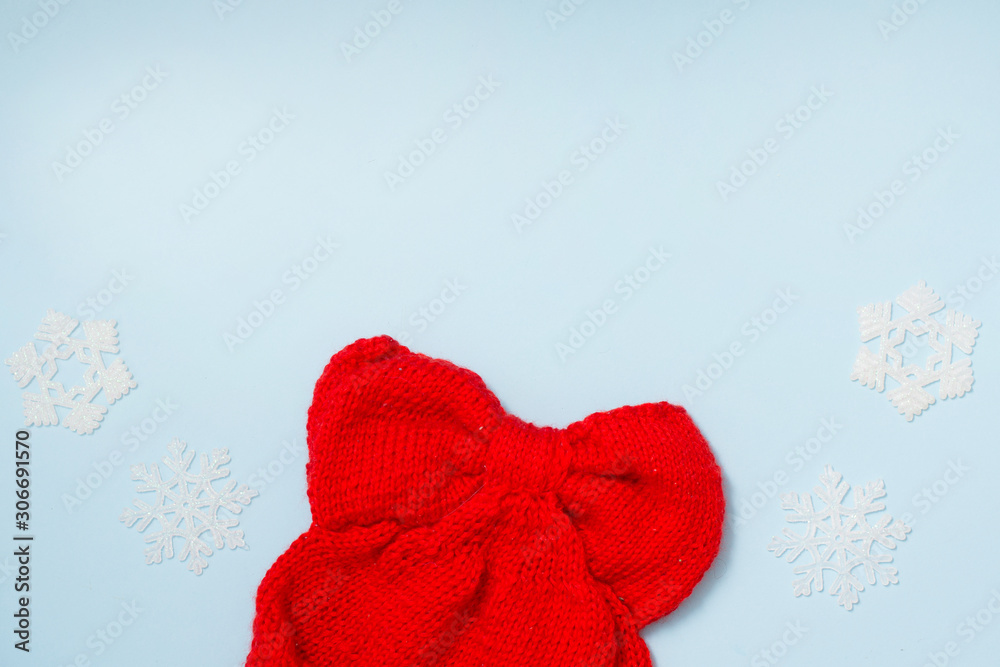winter cloth red hat with decor snowflakes on blue background , copy space