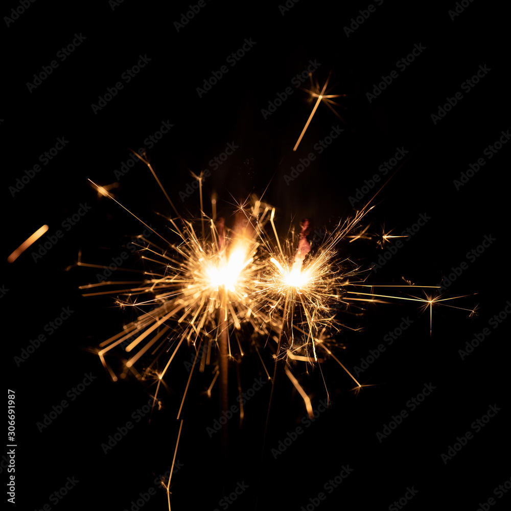 Firework sparkler burning isolated black background.
