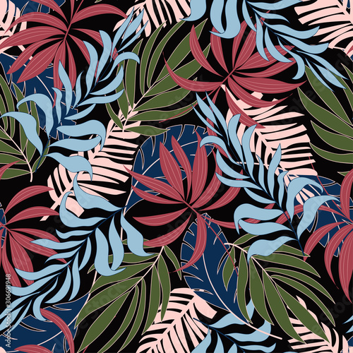 Trend seamless tropical pattern with bright pink and green plants and leaves on black background. Seamless exotic pattern with tropical plants. Tropic leaves in bright colors.