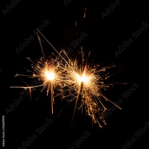 Firework sparkler burning isolated black background.