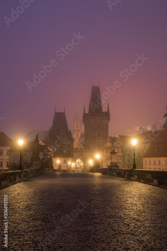 Landscapes on Charles Bridge with Bridge Tower and Statues at sunrise in a foggy morning, Prague, Czech Republic, Europe