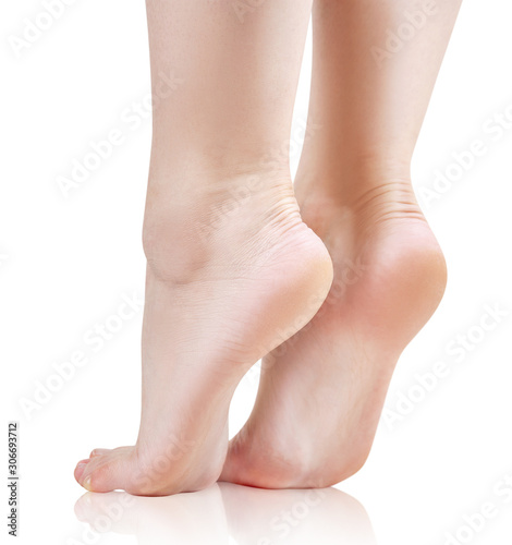 Bare female feet closeup. Isolated on white background.