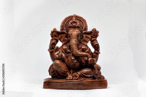 wooden statue of Hindu god Ganesha with a white background, Hindu religion