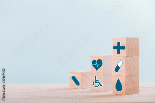 Fototapeta Naklejka Na Ścianę i Meble -  Emoticon icons healthcare medical symbol on wooden block , Healthcare and medical Insurance concept