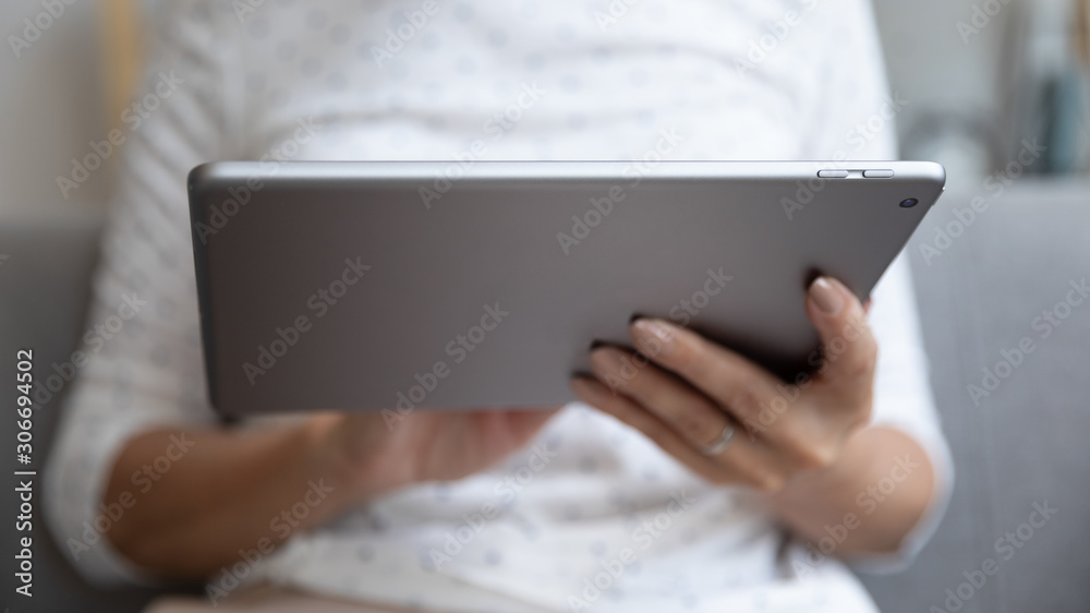 Closeup view female hands holding digital electronic device tablet computer Closeup view female hands holding digital electronic device tablet computer