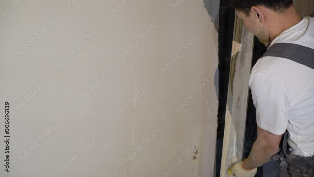 Plastering mortar machine. Automatic plaster. Repairing or renovating house or apartment. Builder at construction professional Plastering mortar machine. Automatic plaster. Repairing or renovating house or apartment. Builder at construction professional