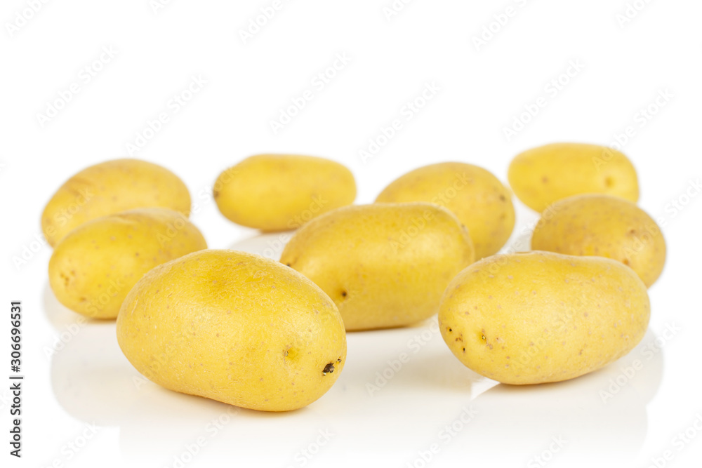 Lot of whole pale yellow potato isolated on white background