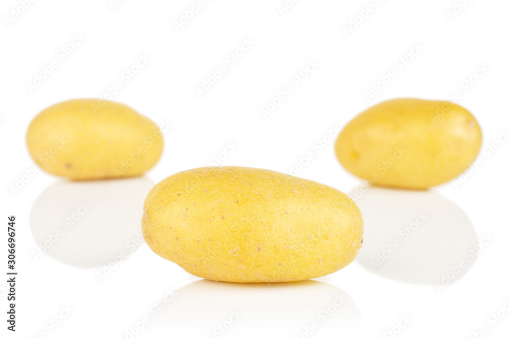 Group of three whole pale yellow potato isolated on white background