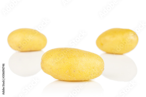 Group of three whole pale yellow potato isolated on white background