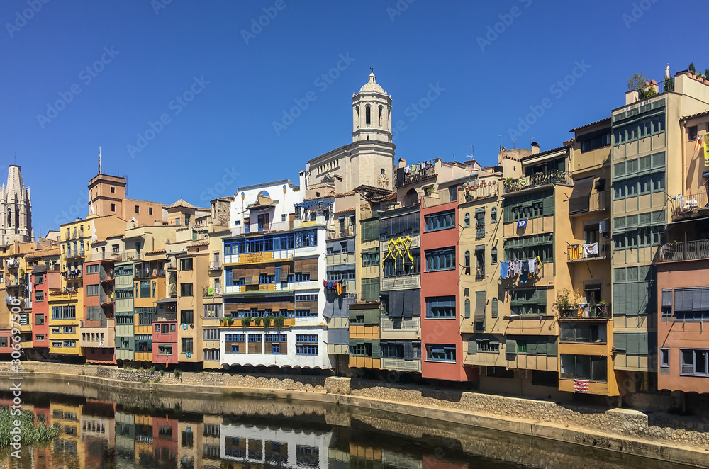 Buildings in residential district in Girona on bank of Onyar river with cathedral view 