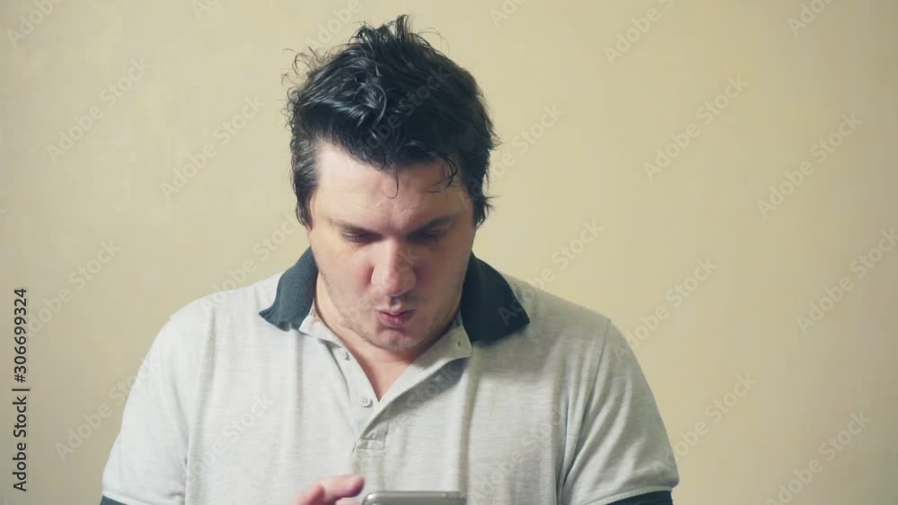 funny freak laughs looking into smartphone. humorous portrait of an emotional man funny freak laughs looking into smartphone. humorous portrait of an emotional man