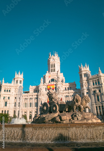 Cibeles fountain and Cibeles Palace at Plaza de Cibeles in Madrid in a beautiful summer day, Spain