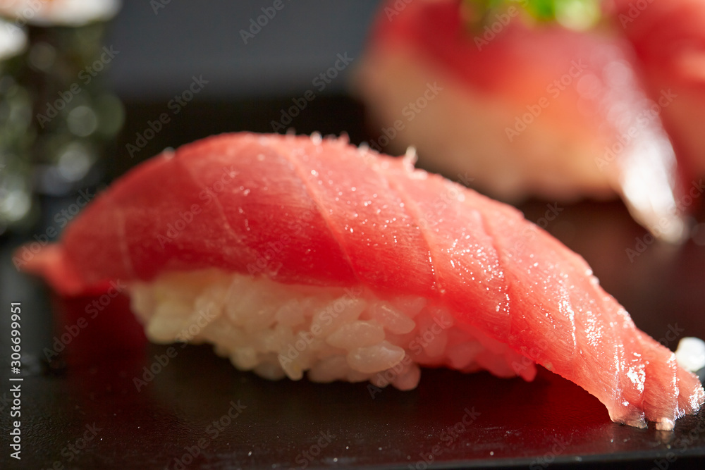 Bonito and tuna sushi on black plate Bonito and tuna sushi on black plate
