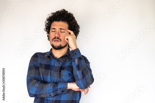 Latin American man, tired expression, neutral background 